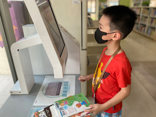 Self-service Book Checkout and Return Machines-children use